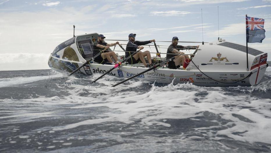 Crew rowing HMS Oardacious